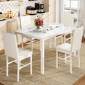 Table de salle à manger moderne avec plateau en verre trempé et chaises en cuir PU avec surpiqûres diamant